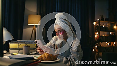 Boring girl reading smartphone at home closeup. Serious woman watching mobile Stock Photo