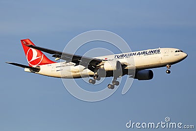 TC-JNA Turkish Airlines Airbus A330-203 aircraft in the sunset rays on the blue sky background Editorial Stock Photo