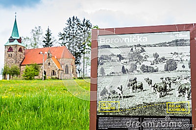 Borovnicka, Czech republic - May 15, 2021. Information board about village with Church Of The Divine Heart Of The Lord in backgrou Editorial Stock Photo