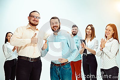 Boss approving and congratulating young successful employee Stock Photo