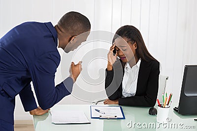 Boss Blaming Female Executive Stock Photo