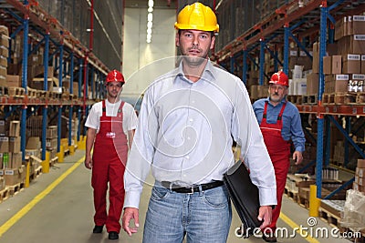 Boss with briefcase at the front of workforce Stock Photo