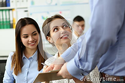 Boss or coach mentor coach showing young female trainee document on training. Stock Photo