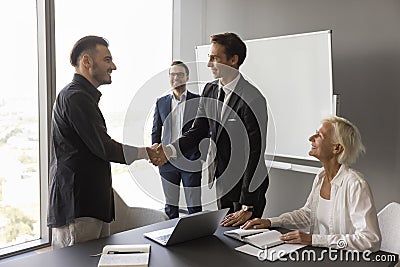 Boss expressing recognition to best manager, employee, giving handshake Stock Photo