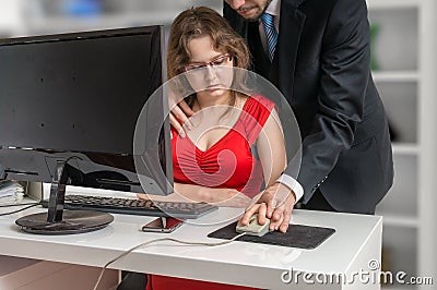 Boss or manager is seducting his secretary in office. Harassment concept. Stock Photo