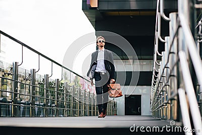 The Boss In A Suit And Sunglasses With A Briefcase In His Hand Goes To Work Stock Photo