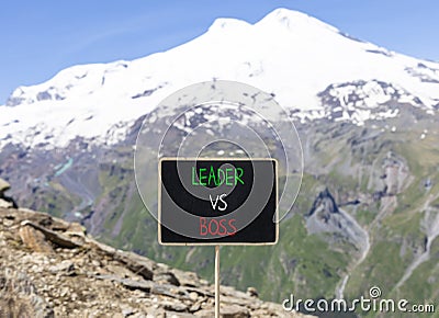 Boss vs leader symbol. Concept words Boss vs versus leader on beautiful black chalk blackboard. Beautiful mountain Elbrus Stock Photo