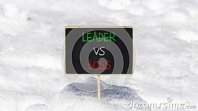 Boss vs leader symbol. Concept words Boss vs versus leader on beautiful black chalk blackboard. Beautiful snow background. Stock Photo