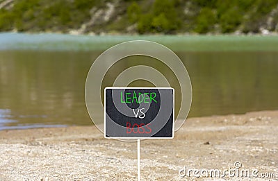 Boss vs leader symbol. Concept words Boss vs versus leader on beautiful black chalk blackboard. Beautiful mountain lake background Stock Photo