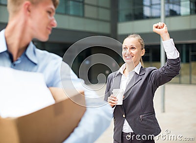 Boss woman is wishing good luck to office worker Stock Photo
