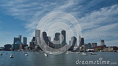 Boston Massachusetts harbor and city skyline over water with sailboats Stock Photo