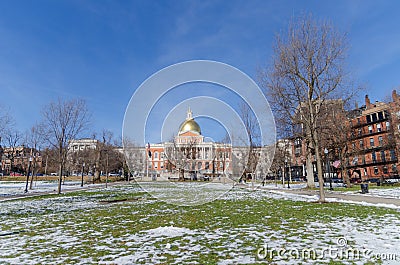 Boston, USA - December 08, 2019: Winter day in the public park with snow and the view of Boston State House Editorial Stock Photo