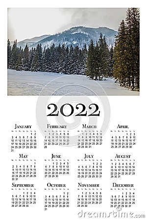 Botanical calendar for 2022. Printable wall calendar, week starts on Monday. Beautiful winter landscape in the Polish mountains Stock Photo