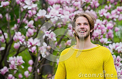 Botanical garden. Freshness and awakening. Tender flowers. Hipster enjoy blossom. Springtime concept. Guy relax in Stock Photo