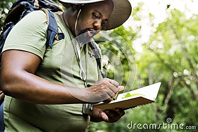 Botanist making notes in his notepad Stock Photo