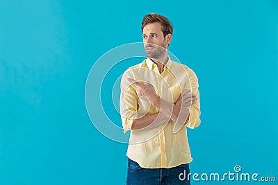 Bothered casual man pointing to the side and indicating Stock Photo