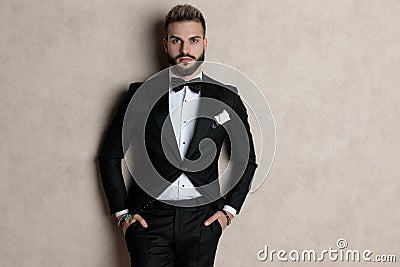 Bothered groom looking forward with both hands in his pockets Stock Photo