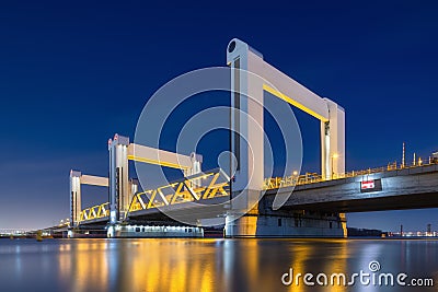Botlek bridge, Rotterdam, Netherlands. View of the bridge at night. Road for cars and railroad transport. Architectural landscape. Editorial Stock Photo