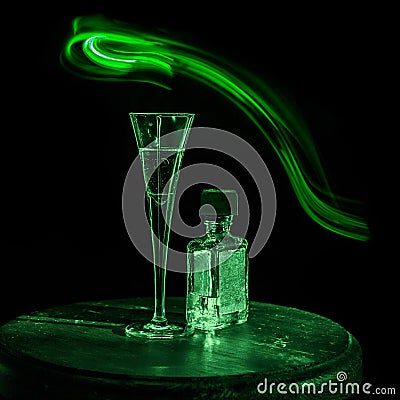 Bottle of alcohol, glass and stripe of light Stock Photo