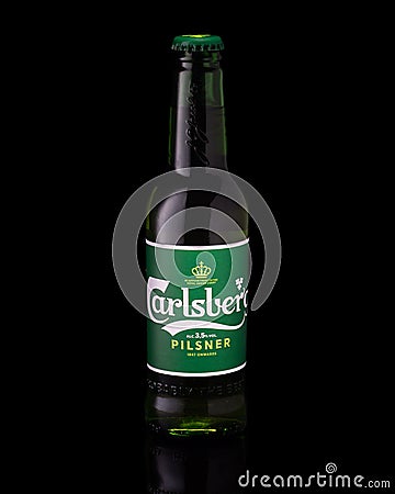 Bottle of beer Carlsberg on black background, studio shooting, vertical Editorial Stock Photo
