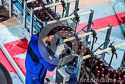 Bottle Beer Production with worker Editorial Stock Photo