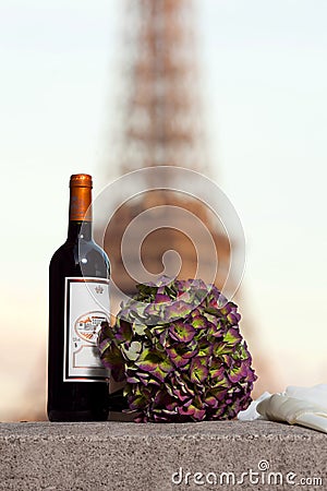 Bottle and a bouquet of flowers near the Eiffel Tower Stock Photo