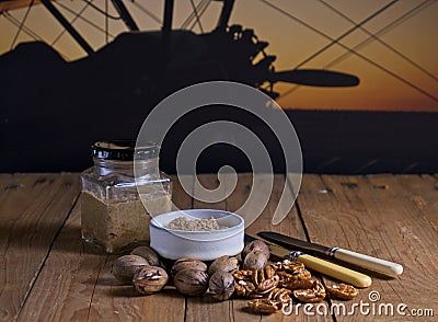 Bottle and bowl of pecan nut butter with silhouette of airplane in background Stock Photo