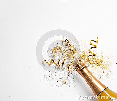 Bottle of champagne with gold glitter, confetti on white background, top view. Hilarious celebration Stock Photo