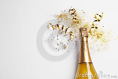 Bottle of champagne with gold glitter, confetti and space for text on white background, top view. Hilarious Stock Photo