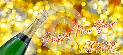 Bottle of champagne, inscription happy new year 2022 on background of bright festive golden bokeh Stock Photo