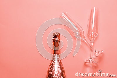 Bottle of champagne or sparkling wine with a couple of glasses on pink background Stock Photo