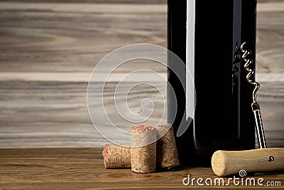Bottle, corkscrew and cork are on the table Stock Photo