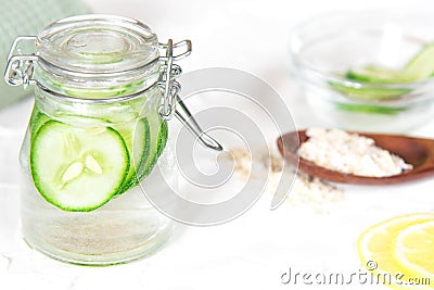 Bottle with cucumber water on white background. Fresh skin care tonic Stock Photo