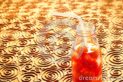 Bottle delicious refreshing drink of vibrant watermelon with drinking straw, infusioned water, soft focus and warm tone Stock Photo