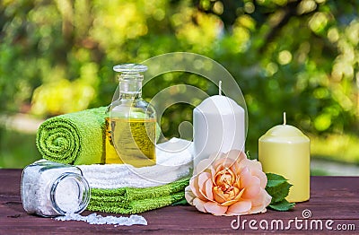 Bottle of essential oil and sea salt. Rose and candles. Set for Spa treatments Stock Photo