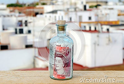 Bottle with fifty pound sign inside Editorial Stock Photo