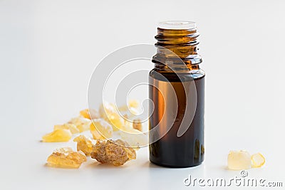 A bottle of frankincense essential oil with frankincense on whit Stock Photo