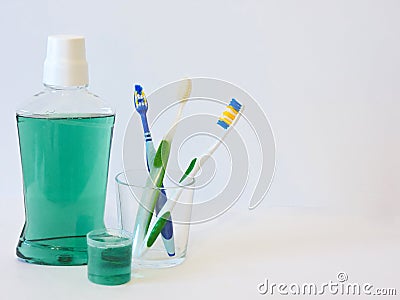 Bottle and glass of mouthwash on bath shelf with toothbrush. Dental oral hygiene concept. Set of oral care products Stock Photo