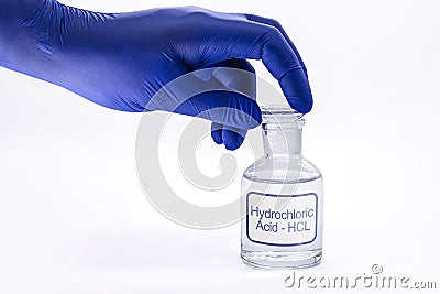 Bottle of hydrochloric acid, handling with glove for chemist, chemical solution used in the industry in general, toxic and Stock Photo