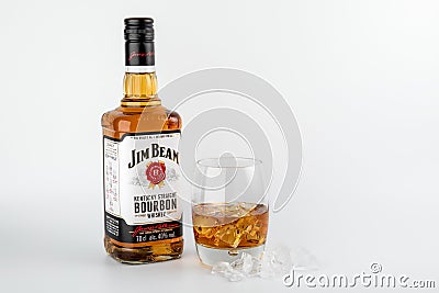 Bottle of Jim Beam Bourbon and a glass with ice on white background Editorial Stock Photo