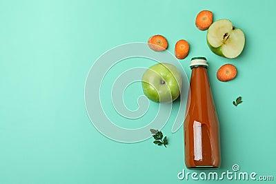 Bottle of juice and ingredients on mint background Stock Photo