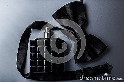 Bottle of male perfume and bow tie Stock Photo