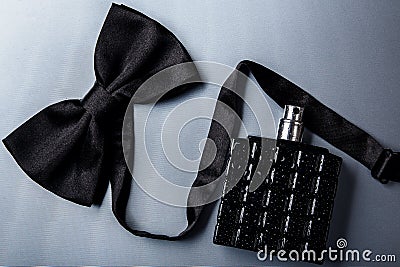 Bottle of male perfume and bow tie Stock Photo