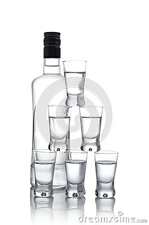 Bottle with many glasses of vodka isolated on white background Stock Photo