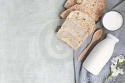 A bottle of milk and glass of milk with sliced bread and wooden Stock Photo