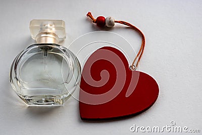 Bottle of perfume with red hearts flying out from it. Valentine`s day, choosing fragrance, pheromones Stock Photo