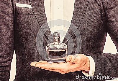 Bottle and perfumery, cosmetics, scent cologne bottle, male holding cologne. Masculine perfume. Male holding up bottle Stock Photo