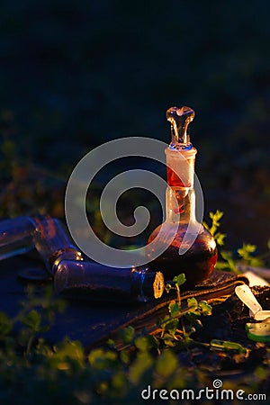 A bottle of potion on a background of magical ingredients Stock Photo