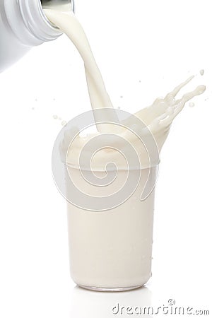 Bottle pouring milk into a glass. Stock Photo