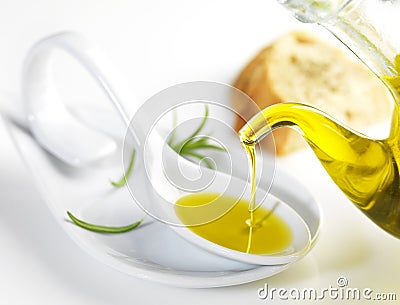 Virgin olive oil pouring in a spoon Stock Photo